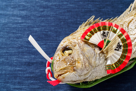 Whole grilled sea bream with saltの写真素材