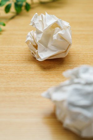 Crumpled paper ball on wooden table