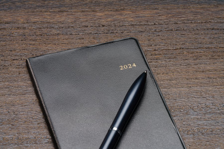 2024 Notebook and pen on wooden table (2024 schedule book)