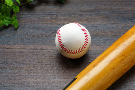 Baseball bat and ball on wooden backgroundの写真素材