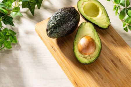 Fresh organic avocado on wooden table