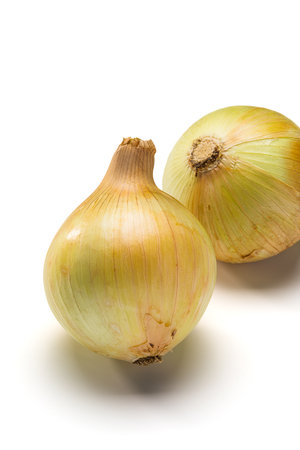 Raw unpeeled onions on white backgroundの写真素材