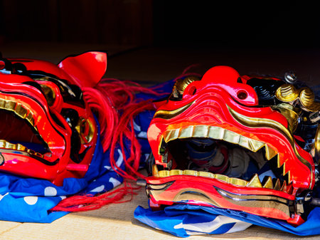 Traditional Japanese Shishimai Lion Dance Masks on Tatami Matの写真素材