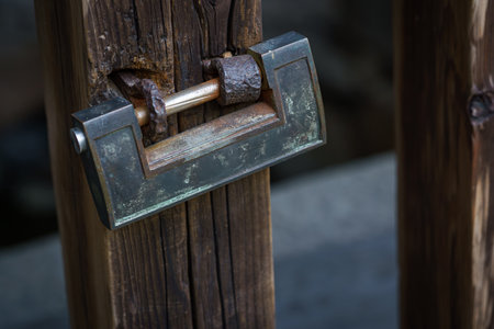 Rusty padlock on old wooden gateの写真素材