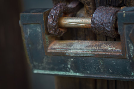 Rusty padlock on old wooden gateの写真素材