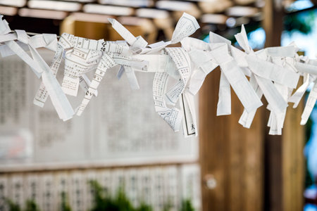 Omikuji Fortune Papers Tied at a Shrine at a Japanese Templeの写真素材