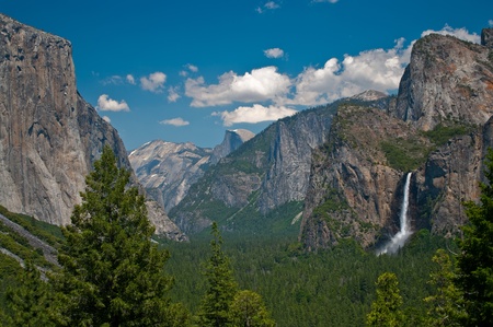 Yosemite Valley in June:  Waterfalls and rocky cliffs create dramatic scenery in Yosemite National Park.の写真素材