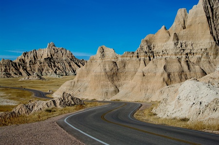 Park Road   A paved road winds through Badlands National Park の写真素材