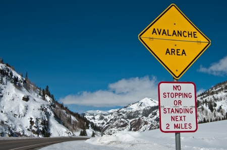 Avalanche Area Sign:  A convertible sign alerts winter travelers to possible snow slides in the Rocky Mountains of southwest Colorado. の写真素材