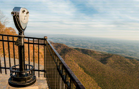 Scenic Overlook Viewer:  A binocular scope on a high rocky ledge offers a spectacular view of the Appalachian Mountains on an autumn day in western South Carolina.の写真素材
