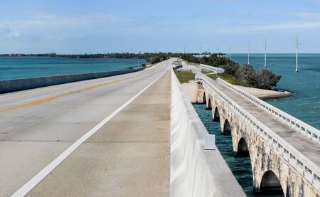 Overseas Highway:  A modern bridge passes beside its older counterpart (now a fishing pier) as US Route 1 connects the Florida Keys and divides the Atlantic Ocean from the Gulf of Mexico.の写真素材