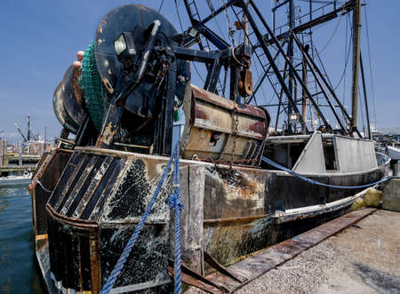 Old Trawler:  A work-worn net fishing boat rests at a New England dock.