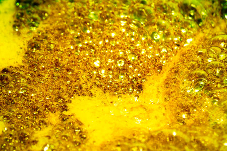 Golden foam. Background and texture concept - close up of bubbling golden foam. Foam texture as backgroundの写真素材