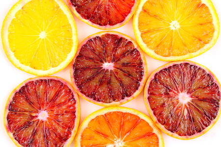 slices of fresh blood orange fruits as food background textureの写真素材