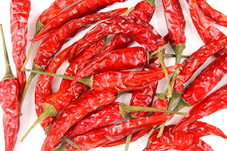 dried thai chili peppers isolated on a white background as a food background texture