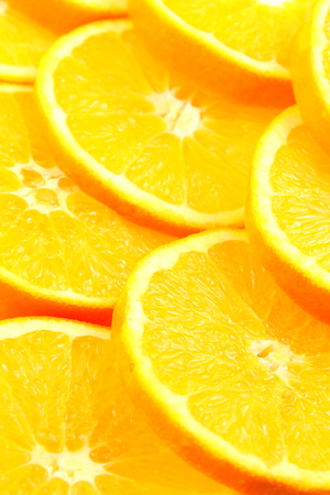 slices of fresh orange fruits as a food background texture