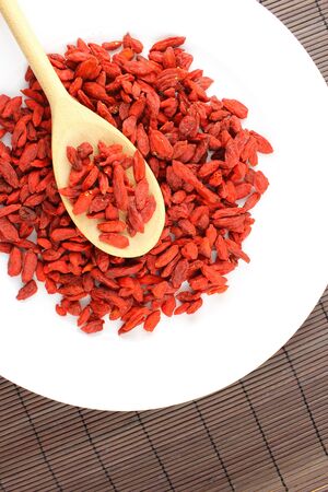 composition of dried goji berries on a wooden spoonの写真素材