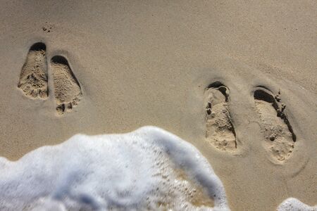 Woman and Man Footprints on Beach. Useful for Honeymoon Concept.の写真素材