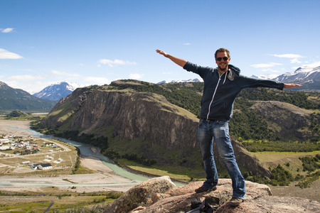 Young man on top of a mountain in El Chalten, Argentinaの写真素材