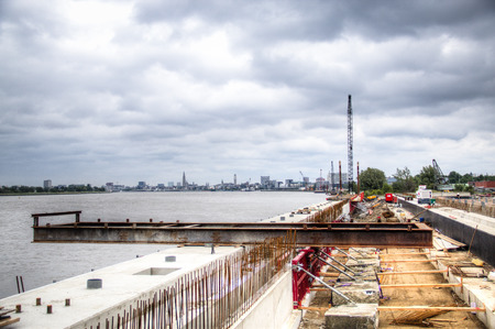 Construction works at the docks of the Schelde river with the Antwerp skyline in the backgroundのeditorial素材