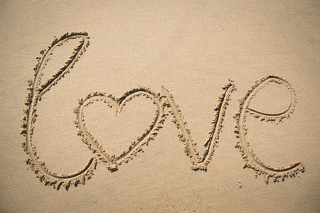 The word love written in the sand on a beach in Mozambiqueの写真素材