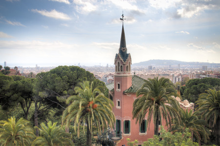 The Gaudi museum in the center of parque Guell with the city skyline in the background in Barcelona in Spainのeditorial素材
