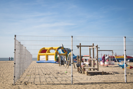 KNOKKE, BELGIUM - MAY 2016: A beach play ground behind a fence in Knokke, Belgiumのeditorial素材