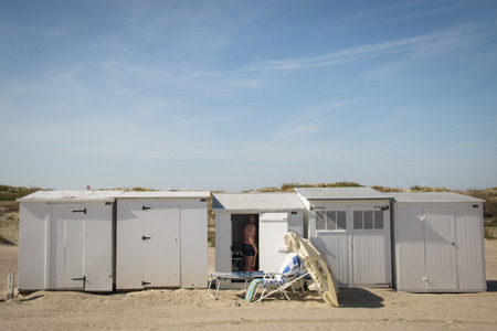 KNOKKE, BELGIUM - MAY 2016: People on the beach surrounded by the typical cabins in Knokke, Belgiumのeditorial素材