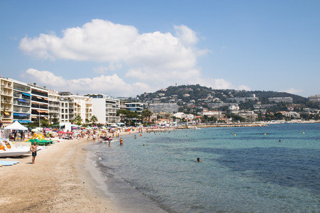CANNES, FRANCE - JULY 2016: People, tents and kayaks on the beach in the popular holiday city Cannes in Franceのeditorial素材