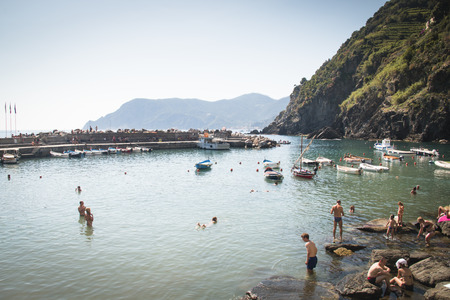 VERNAZZA, ITALY - JULY 2016: People on the beach of the cosy town Vernazza in Cinque Terre in Italyのeditorial素材