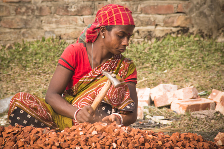 SRIMANGAL, BANGLADESH - FEBRUARY 2017: hard working women cutting stones in a village near Srimangal in Bangladeshのeditorial素材