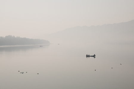 Fishermen on a small fishing boat on a river near Cox's Bazar in Bangladeshの写真素材