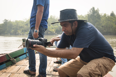 SUNDARBANS, BANGLADESH - FEBRUARY 2017: Film crew on a smal boat on a river in Sundarbans in...