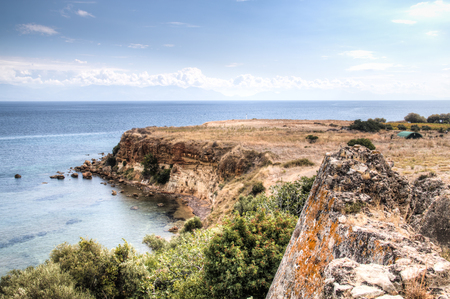 View over the bay with crystal clear water and typical houses in Koroni, Messinia, Greeceの写真素材