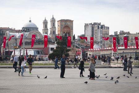 ISTANBUL, TURKEY - OCTOBER 2017: View over Taksim square with many people and Turkish Flags in Istanbul, Turkeyのeditorial素材