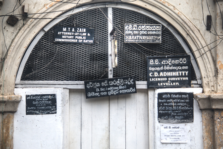 KANDY, SRI LANKA - DECEMBER 2017: Historic walls with lots of signs for attorneys and notaries in the center of Kandy in Sri Lankaのeditorial素材