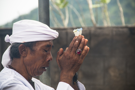 PEMUTERAN, BALI - JANUARY 2018: A hindu priest performing offerings in a temple in Pemuteran in Bali, Indonesiaのeditorial素材