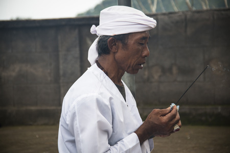PEMUTERAN, BALI - JANUARY 2018: A hindu priest performing offerings in a temple in Pemuteran in Bali, Indonesiaのeditorial素材