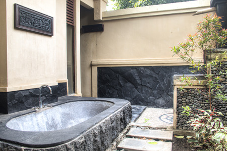Outdoor bathroom with stone bath in a fancy hotel in Pemuteran in Bali, Indonesiaのeditorial素材