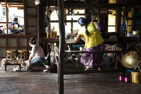 INLE LAKE, MYANMAR - MARCH 2018: People weaving clothes in the traditional way near Inle Lake, one of the top tourist attractions of Myanmarのeditorial素材