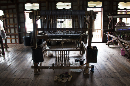 INLE LAKE, MYANMAR - MARCH 2018: People weaving clothes in the traditional way near Inle Lake, one of the top tourist attractions of Myanmarのeditorial素材