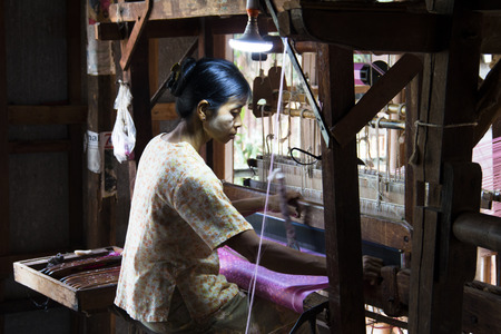 INLE LAKE, MYANMAR - MARCH 2018: People weaving clothes in the traditional way near Inle Lake, one of the top tourist attractions of Myanmarのeditorial素材