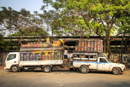 MANDALAY, MYANMAR - MARCH 2018: People loading two trucks full of eggs in Mandalay in Myanmarのeditorial素材