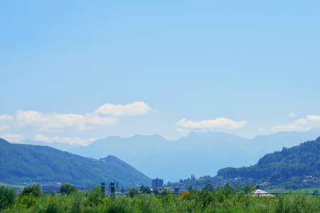 beautiful landscape view of the aare river and the mountains in the distanceの写真素材
