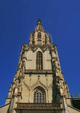 the beautiful view of the Berner mÃ¼nster cathedral tower in the city center of Bern, Switzerlandの写真素材