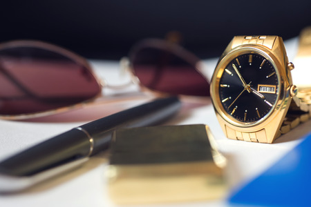Men's accessory, passport, pen, golden watch, sunglasses and lighter on white background.の写真素材