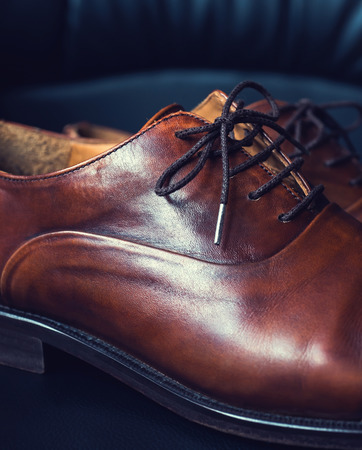 Brown leather men's shoes with wooden shoe stretchers,の写真素材