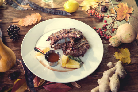 Close up of grilled pork ribs with lemon, sauce and rosmary. Selective Focusの写真素材