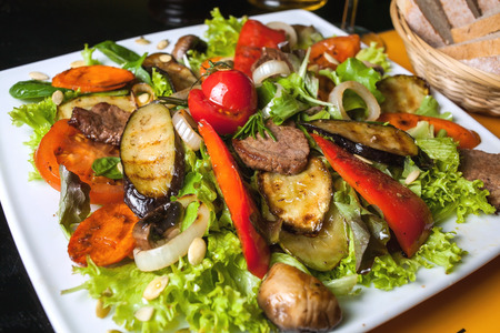 bbq : beef (pork) steak garnished with apples , fresh tomatoes, hot pepper, chives and lettuce.の写真素材