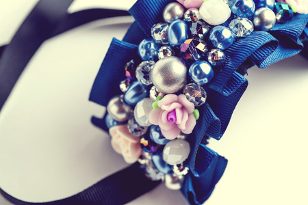 Handmade bracelet with different jewels on white background.. Not isolated. Vintage